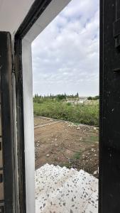 an open window with a view of a field at استراحة بالهدا in Al Hada