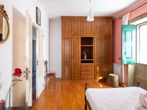 a bedroom with a bed and a wooden cabinet at Holiday Home in Arcozelo with Private Pool in Ponte de Lima