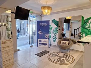 a lobby with a chair and a sign in a store at Hotel Marilian II in Salta