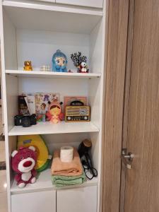 a shelf with toys and other items in a closet at Mei home in Kon Rung (1)
