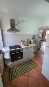 a kitchen with a sink and a stove top oven at Villa Dionisia - Casa Vacanze in Colico +12 photos