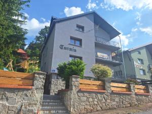 a building with a stone wall in front of it at Willa Turnia Karpacz in Karpacz