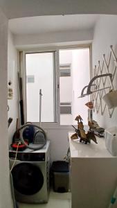 a kitchen with a microwave and a window at Bright apartment in Tangier! in Tangier +3 photos