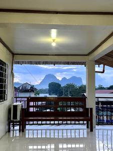 a balcony with a bench and a view of mountains at Casa Huway in El Nido