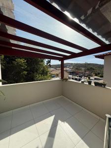 a balcony with awning and a view of a city at Búzios Apartamento Paraiso ll in Búzios