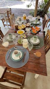 a wooden table with plates of food on it at Viva Vida Caraiva in Caraíva