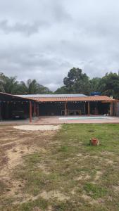 a building with a picnic table in front of it at Chácara Baruk in Iranduba