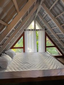 a large bed in a room with a window at Waves Floating Villa in Ambalangoda