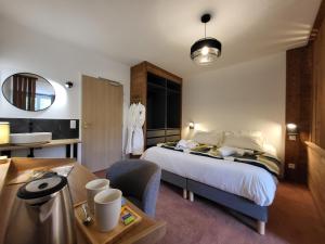 a hotel room with a bed and a desk and a sink at Mille100-47 - Ubaye Base Camp in Faucon-de-Barcelonnette +36 photos