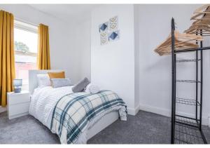 a white bedroom with a bed and a window at Modern 3BD House in Salford, with free parking in Manchester