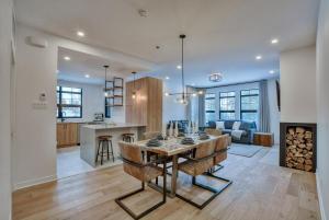 a kitchen and a living room with a dining room table at Tremblant mountain view in Mont-Tremblant