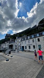 two people flying a kite in front of an old building at Magnifique appartement centre ville de Besançon in Besançon