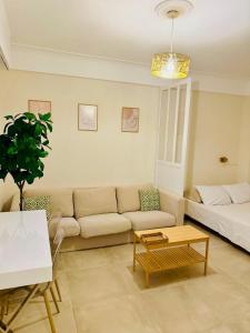 a living room with a couch and a coffee table at Beach and Sun two minutes away in Nice