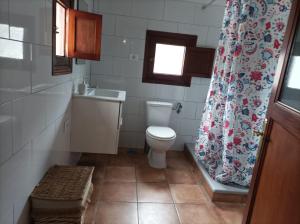 a bathroom with a toilet and a sink and a shower curtain at Vivienda Vacacional Casa Uca in San Pedro +26 photos