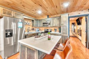 a kitchen with a stainless steel refrigerator and wooden ceilings at Rivers Ledge Cabin with breathtaking views hot tub & indoor pool in Bryant