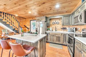 a kitchen with wooden cabinets and a kitchen island at Rivers Ledge Cabin with breathtaking views hot tub & indoor pool in Bryant