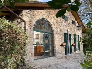 an entrance to a stone building with a glass door at Villa Donati in Piegaro