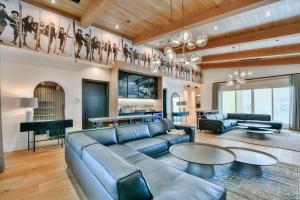 a living room with a blue couch and tables at Tremblant mountain view PH71 in Mont-Tremblant