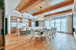 a kitchen and dining room with a table and chairs at Tremblant mountain view PH71 in Mont-Tremblant