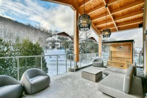 a living room with a balcony with a view at Tremblant mountain view PH71 in Mont-Tremblant