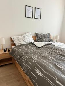 a bedroom with a bed with a gray comforter at Altes Pfarrhaus Amorbach in Amorbach