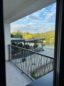 a balcony with a view of a river and a bridge at Apartman Pervan Large in Čapljina +6 photos
