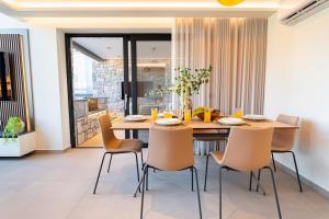 a dining room with a wooden table and chairs at Etheras 2 - Holiday Apartments in Asgourou