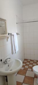 a white bathroom with a sink and a toilet at Leuchars Guest House in Greytown