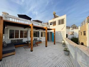 a house with a patio with a roof at Résidence Taghazout Oufella by Surf Times in Taghazout