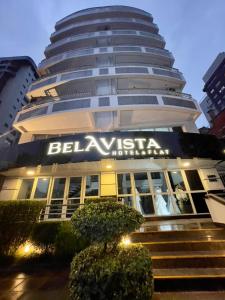 a building with a sign on the side of it at Bela Vista Hotel & Flat in Porto Alegre