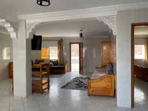 a bedroom with a bed and a living room at Résidence Taghazout Oufella by Surf Times in Taghazout