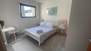 a small bedroom with a bed and a window at Private room and bathroom in shared flat with parking in Glasgow +7 photos