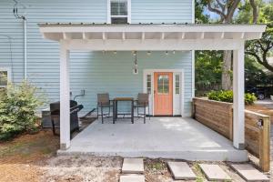 a patio with a table and chairs in front of a house at Ride The Wave 5 min to Beach 7 min to Dtwn in Charleston