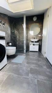 a bathroom with a tub and a sink and a toilet at Luxury Apartment in Böblingen in Böblingen +33 photos