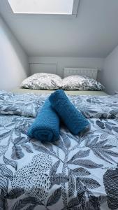 a bed with a blue blanket on top of it at Luxury Apartment in Böblingen in Böblingen