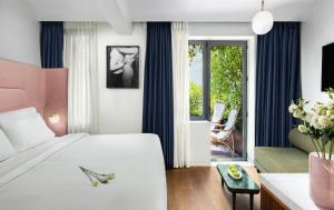 a bedroom with a white bed and a living room at Gatsby Athens in Athens +23 photos