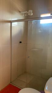 a shower with a glass door in a bathroom at JR POUSADA in Morro do Chapéu