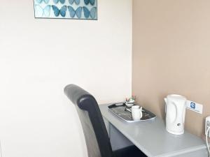 a table in a room with a coffee maker on it at Esk Vale Guest House in Portsmouth