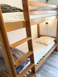 a group of bunk beds in a dorm room at Les Chalets De Superd Bleuet - 2 Pièces pour 6 Personnes MAE-8844 in Le Dévoluy