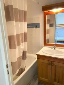 a bathroom with a sink and a tub and a shower at Les Chalets De Superd Bleuet - 2 Pièces pour 6 Personnes MAE-8844 in Le Dévoluy