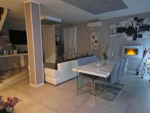 a dining room and living room with a table and chairs at B&B Deluxe in Guastalla