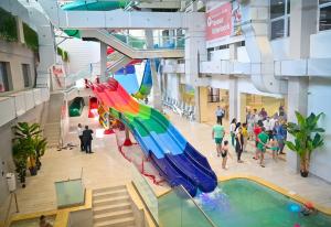 a view of a mall with a pool and umbrellas at Warm Studio in Sibiu