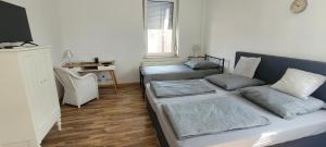 a living room with a bed and a desk at Privileg - NewTime in Viersen