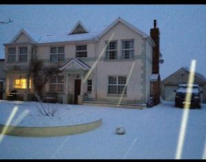 a house with a soccer ball in the snow at Family & friends get together birthday hot tub in Porthcawl