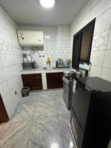 a small kitchen with a sink and a stove at B&B apartments in Yaoundé +11 photos