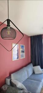 a living room with a blue couch and a lamp at Apartmani Sestosed-Snezna Dolina in Jahorina