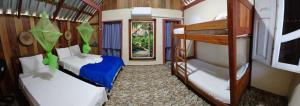 a room with two bunk beds and a hallway at Trapiche Eco Amazon Lodge in Iranduba