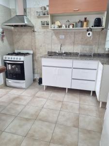 a kitchen with a stove and a sink in it at Renacer in Playa Unión