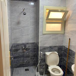 a bathroom with a toilet and a shower at قرية لاجولى السخنه للعائلات فقط in Ain Sokhna