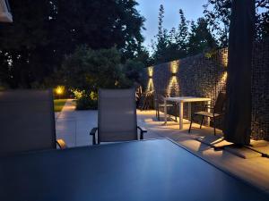 a table and chairs on a patio at night at Leaf & Lounge Twente in Oldenzaal